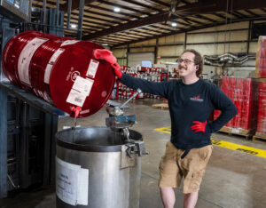 An AFI compounder creating a 400 pound batch of fragrance oil