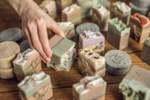 bars of handmade soap being organized on a wooden table